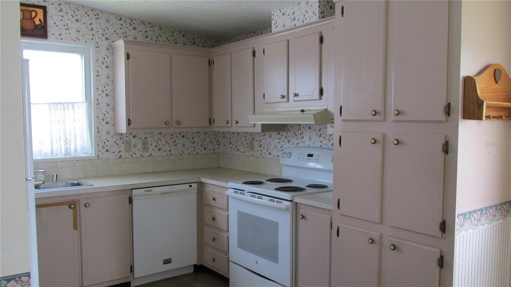 253 Ramsgate Way Haines City, FL 33844 - Photo 7 of 21 a kitchen with cabinets appliances and a window