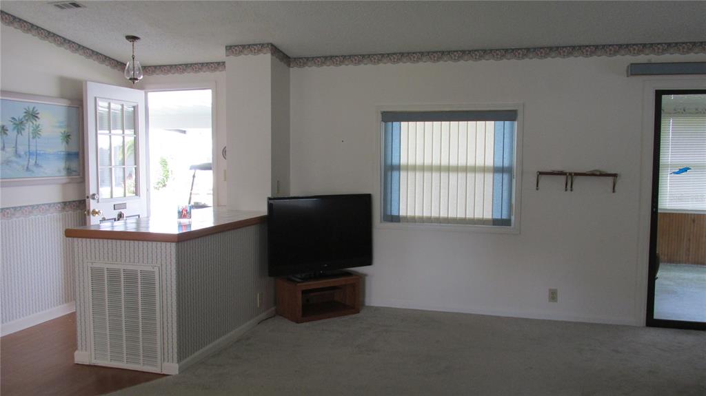 253 Ramsgate Way Haines City, FL 33844 - Photo 9 of 21 a living room with furniture window and a flat screen tv