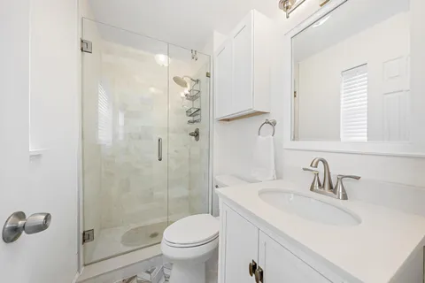a bathroom with a sink toilet and shower