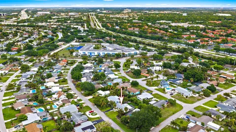 an aerial view of residential houses with city view