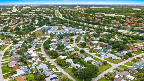 an aerial view of residential houses with city view