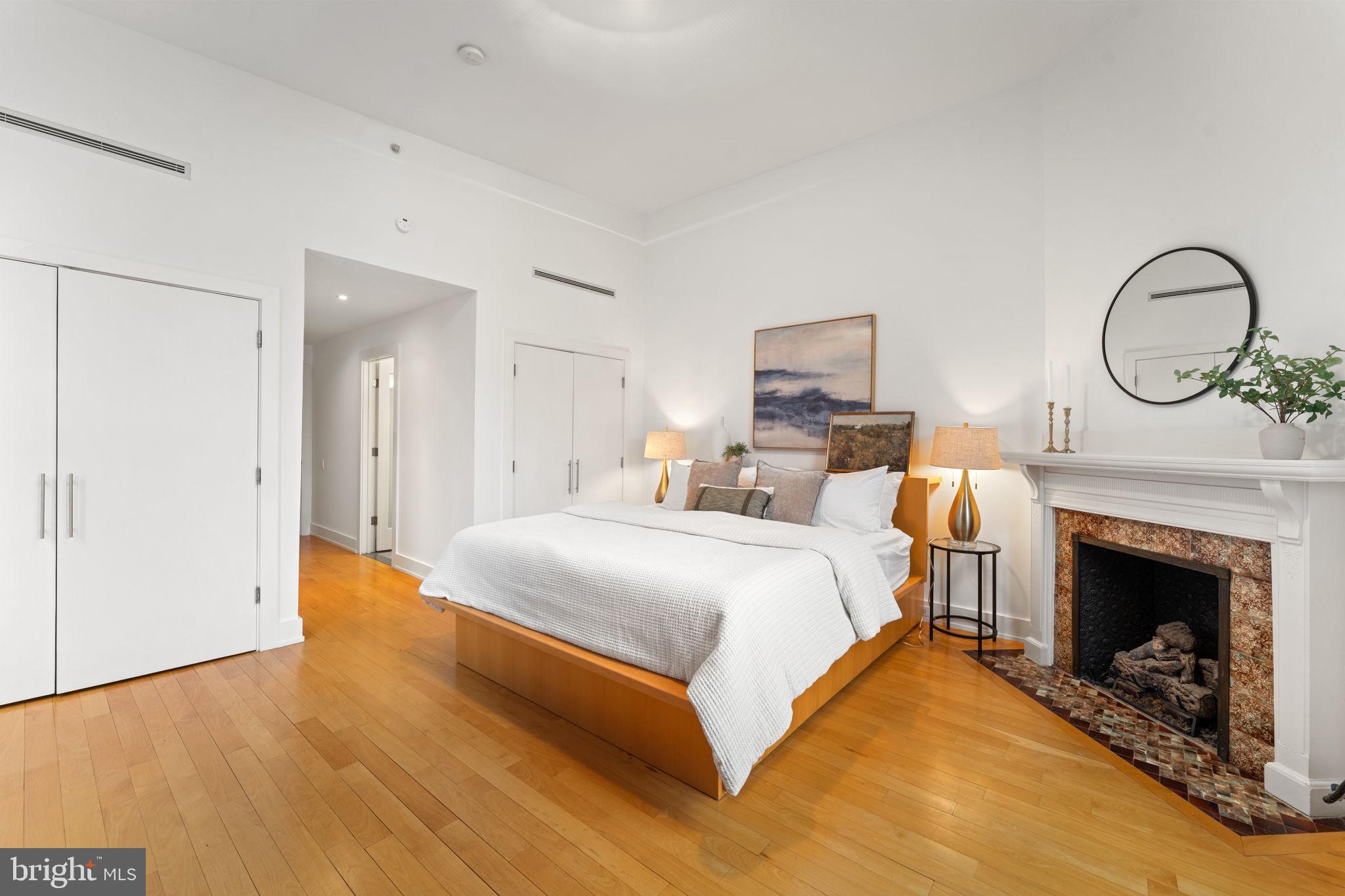 1516 R Street Northwest, Unit 3 Washington, DC 20009 - Photo 21 of 28 a spacious bedroom with a bed and a fireplace