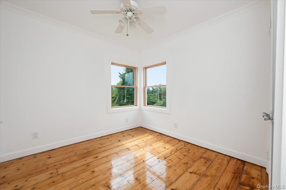 56 Oak Beach Road Babylon, NY 11702 - Photo 22 of 30 Bedroom with original refinished wide plank hardwood floors and new Anderson windows.