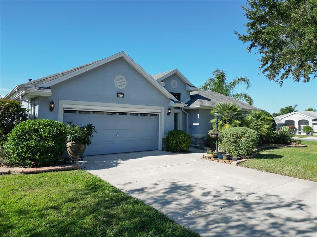 5510 Celebration Way Leesburg, FL 34748 - Photo 40 of 62 a front view of a house with a yard and garage