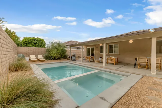 a view of a patio with swimming pool table and chairs
