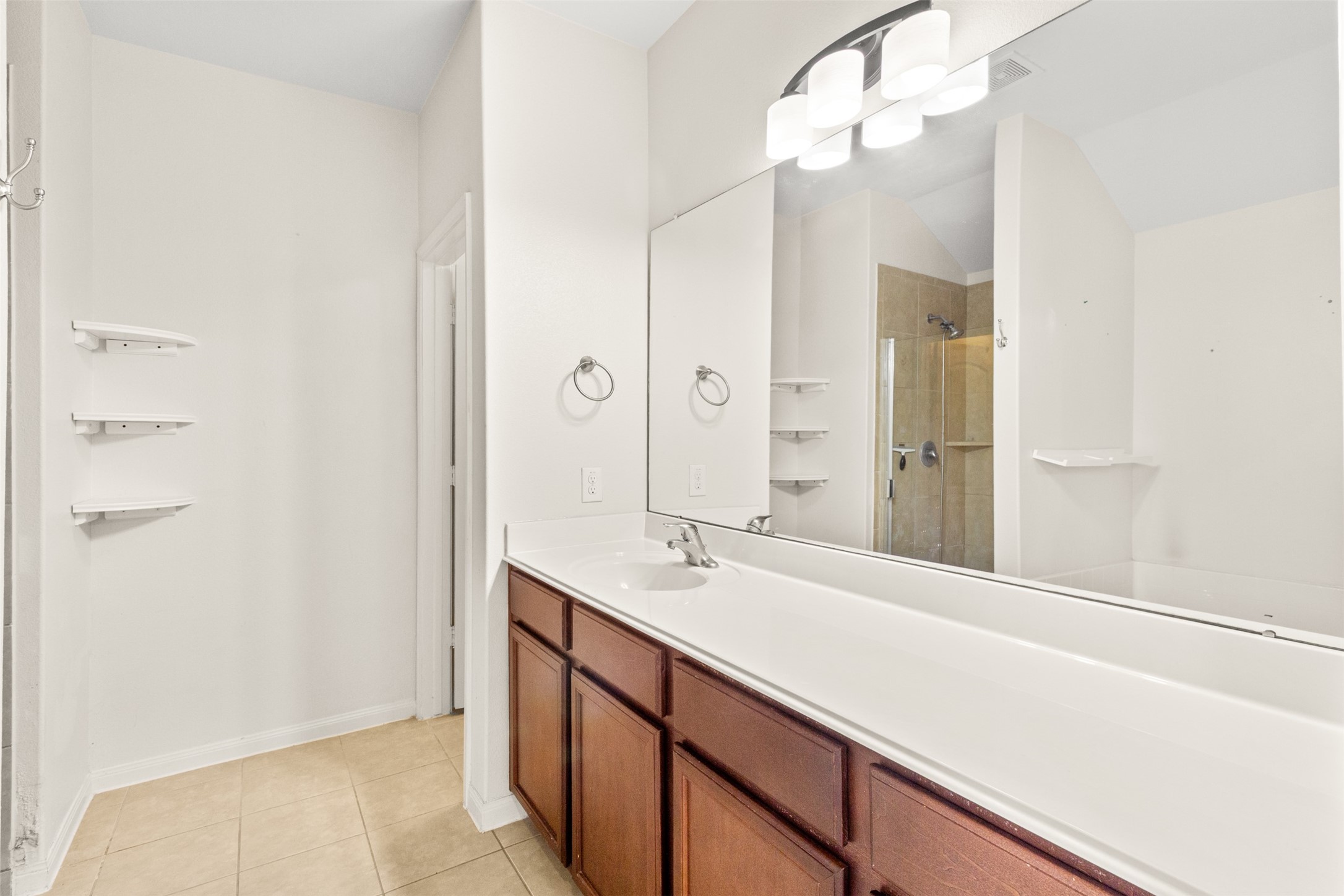 9426 Grand Spark Drive Rosharon, TX 77583 - Photo 16 of 31 The primary bathroom offers generous counter space, making busy mornings easier and more efficient. Abundant storage and thoughtful design help keep daily routines organized.