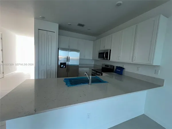 a bathroom with a bathtub sink vanity and toilet
