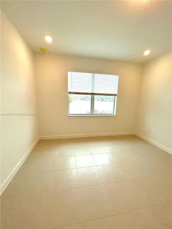 an empty room with a empty space and windows