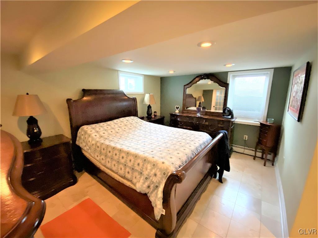314 Willow Road Hellertown, PA 18055 - Photo 23 of 31 a bedroom with a bed and a mirror on dresser