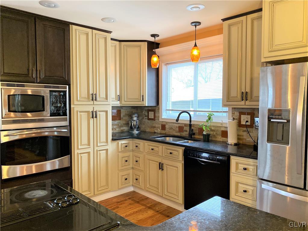 314 Willow Road Hellertown, PA 18055 - Photo 8 of 31 a kitchen with stainless steel appliances a stove sink and cabinets