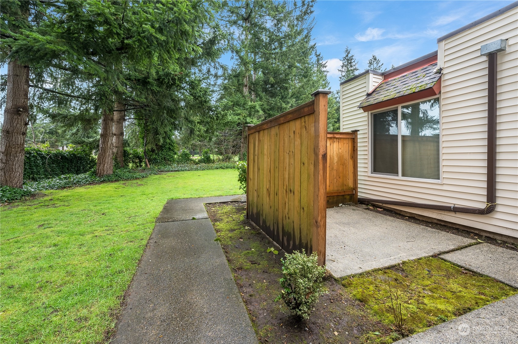 14600 Southeast 176th Street, Unit K8 Renton, WA 98058 - Photo 14 of 17 a view of a back yard with a house