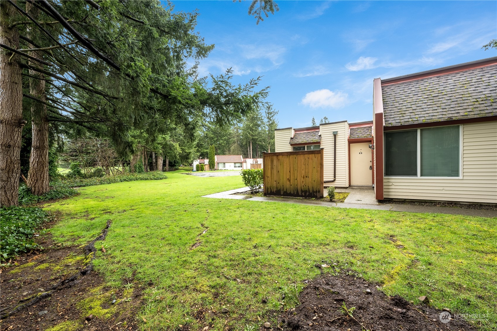 14600 Southeast 176th Street, Unit K8 Renton, WA 98058 - Photo 15 of 17 a view of a backyard with large trees