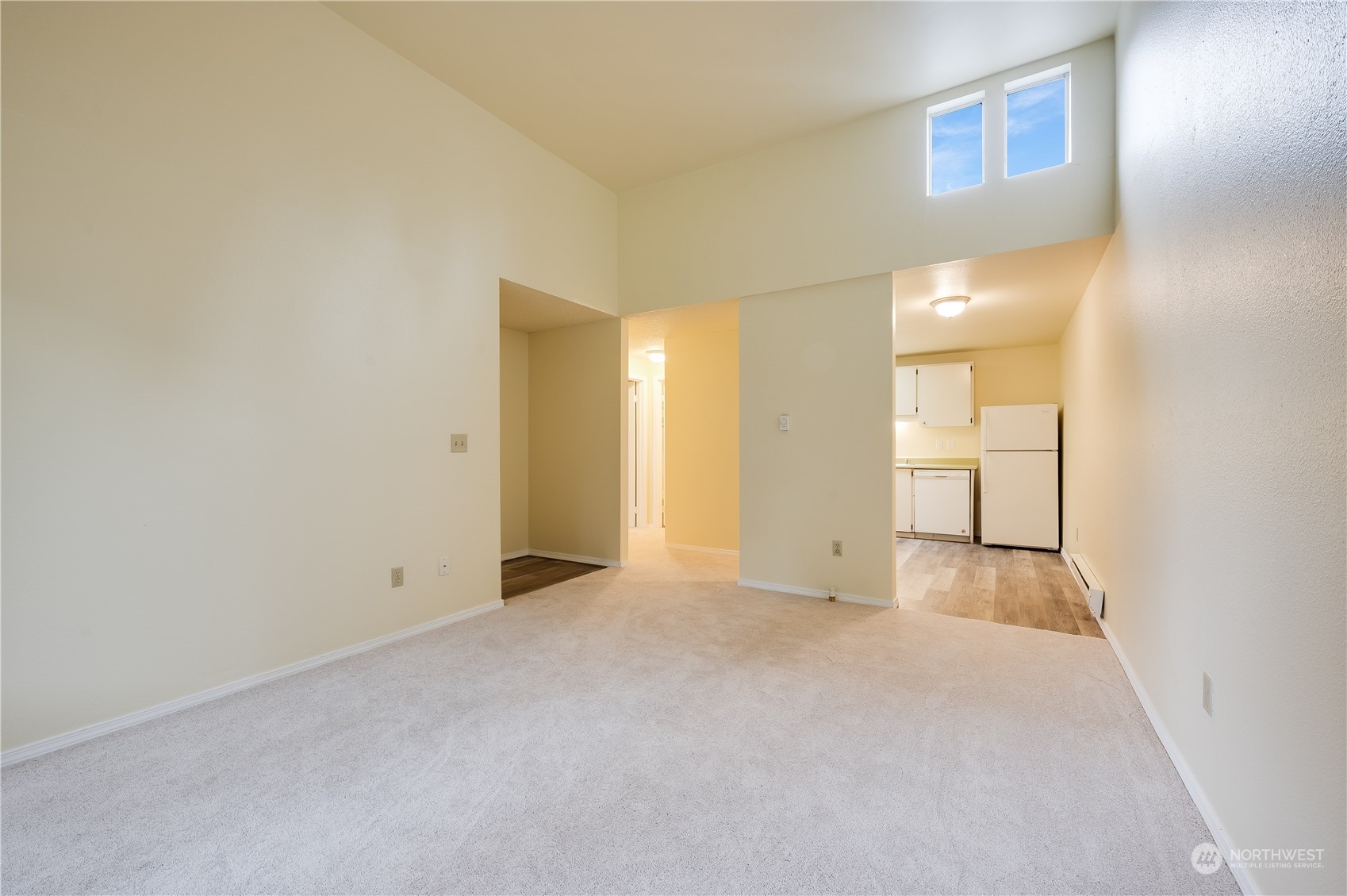 14600 Southeast 176th Street, Unit K8 Renton, WA 98058 - Photo 4 of 17 a view of an empty room with wooden floor and a window