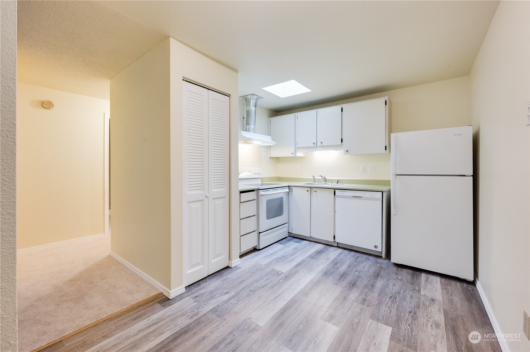 14600 Southeast 176th Street, Unit K8 Renton, WA 98058 - Photo 5 of 17 a kitchen with white cabinets and white appliances