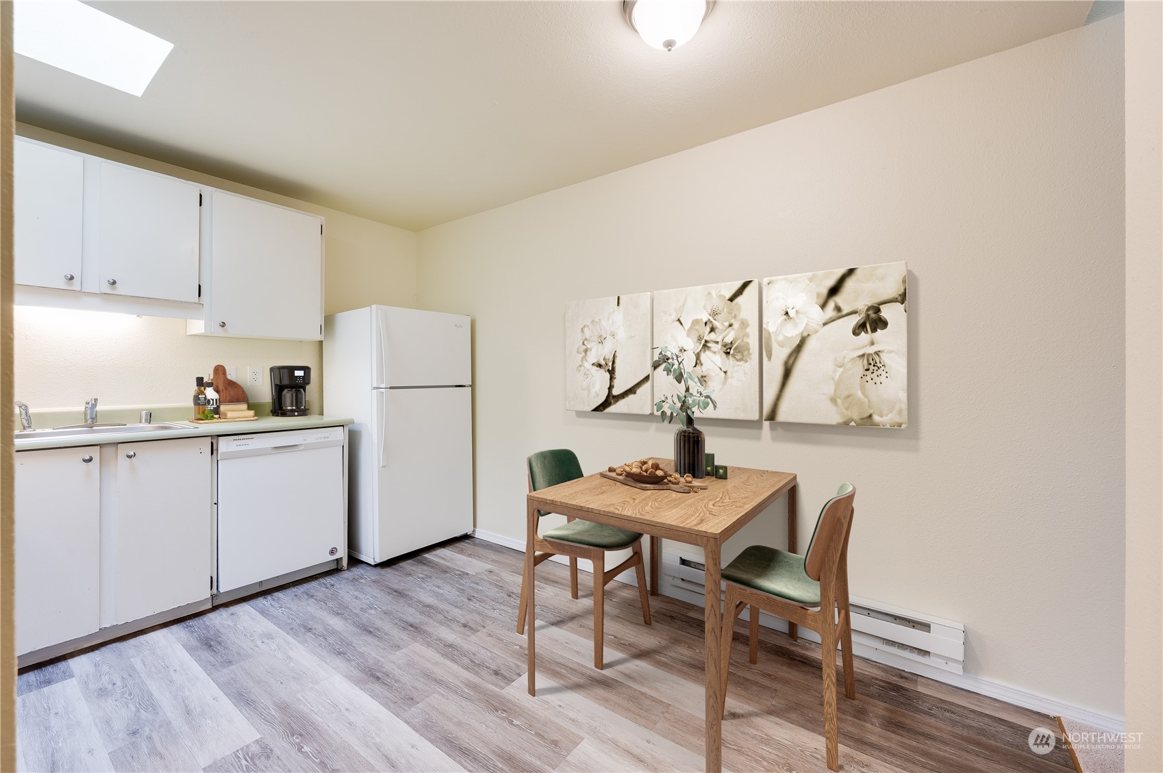 14600 Southeast 176th Street, Unit K8 Renton, WA 98058 - Photo 6 of 17 a kitchen with a table chairs refrigerator and cabinets