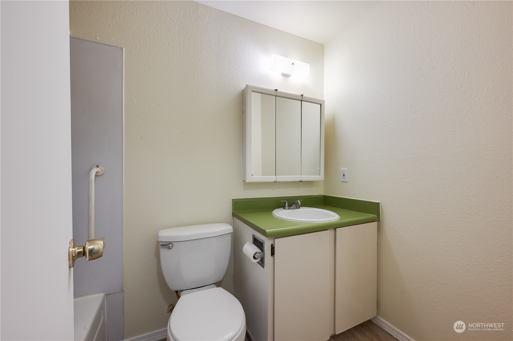 14600 Southeast 176th Street, Unit K8 Renton, WA 98058 - Photo 10 of 17 a bathroom with a granite countertop toilet a sink and a mirror