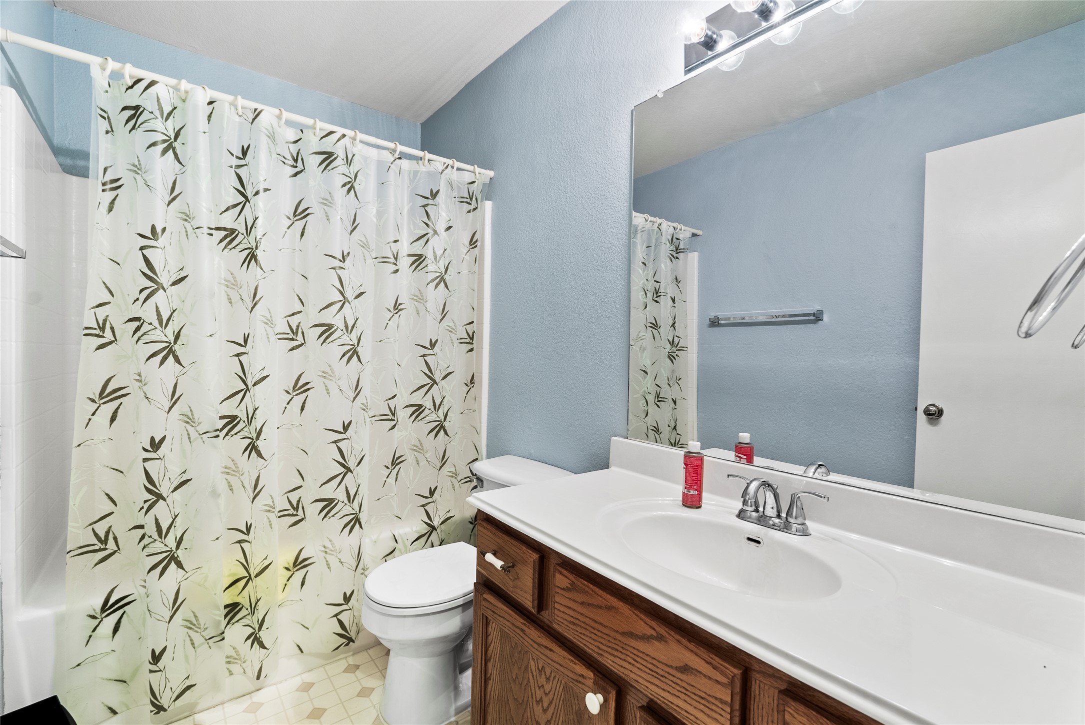 120 Shenandoah Trail Elgin, TX 78621 - Photo 12 of 16 Bathroom featuring shower / bathtub combination with curtain, & vanity