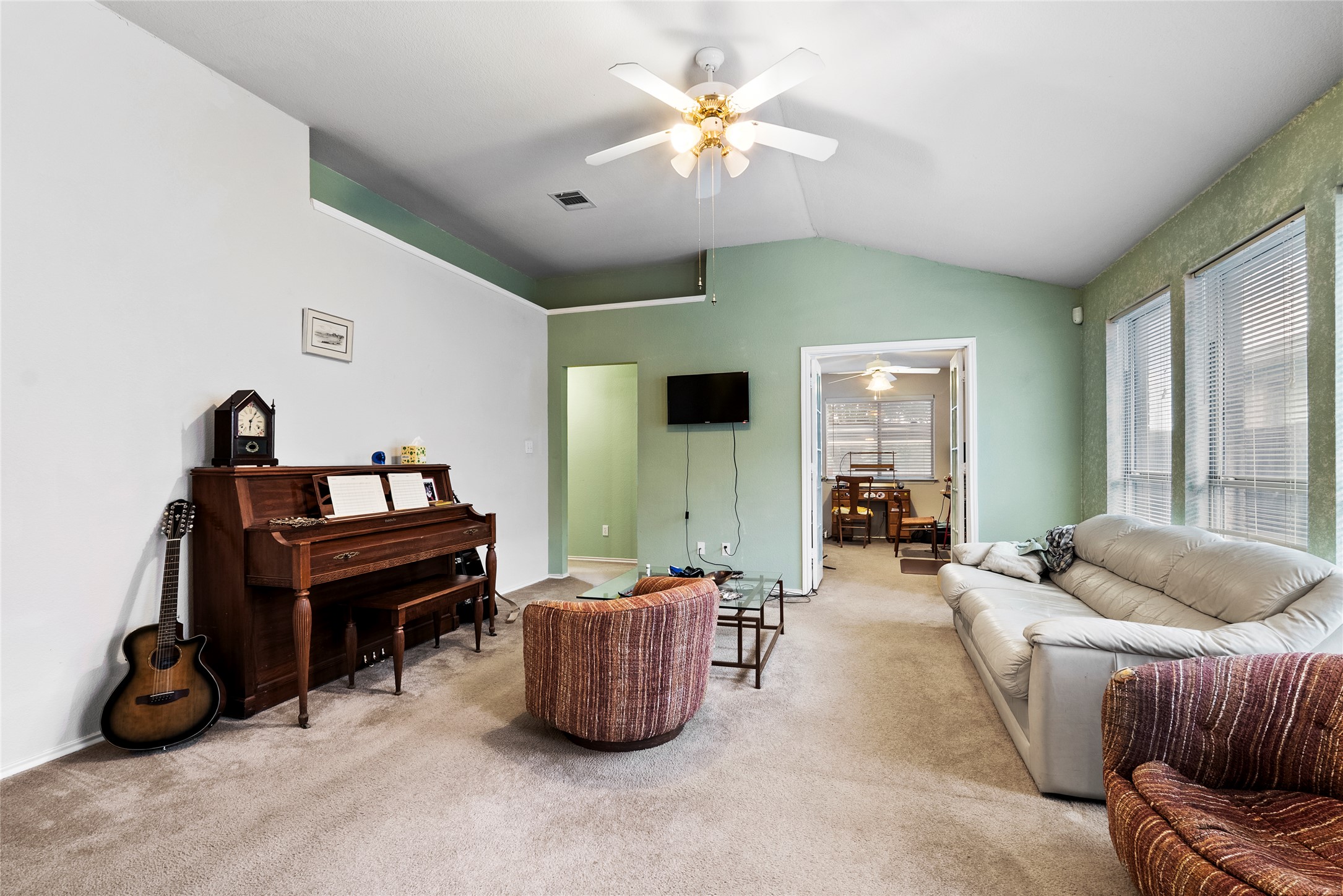 120 Shenandoah Trail Elgin, TX 78621 - Photo 4 of 16 Carpeted living room with vaulted ceiling and ceiling fan