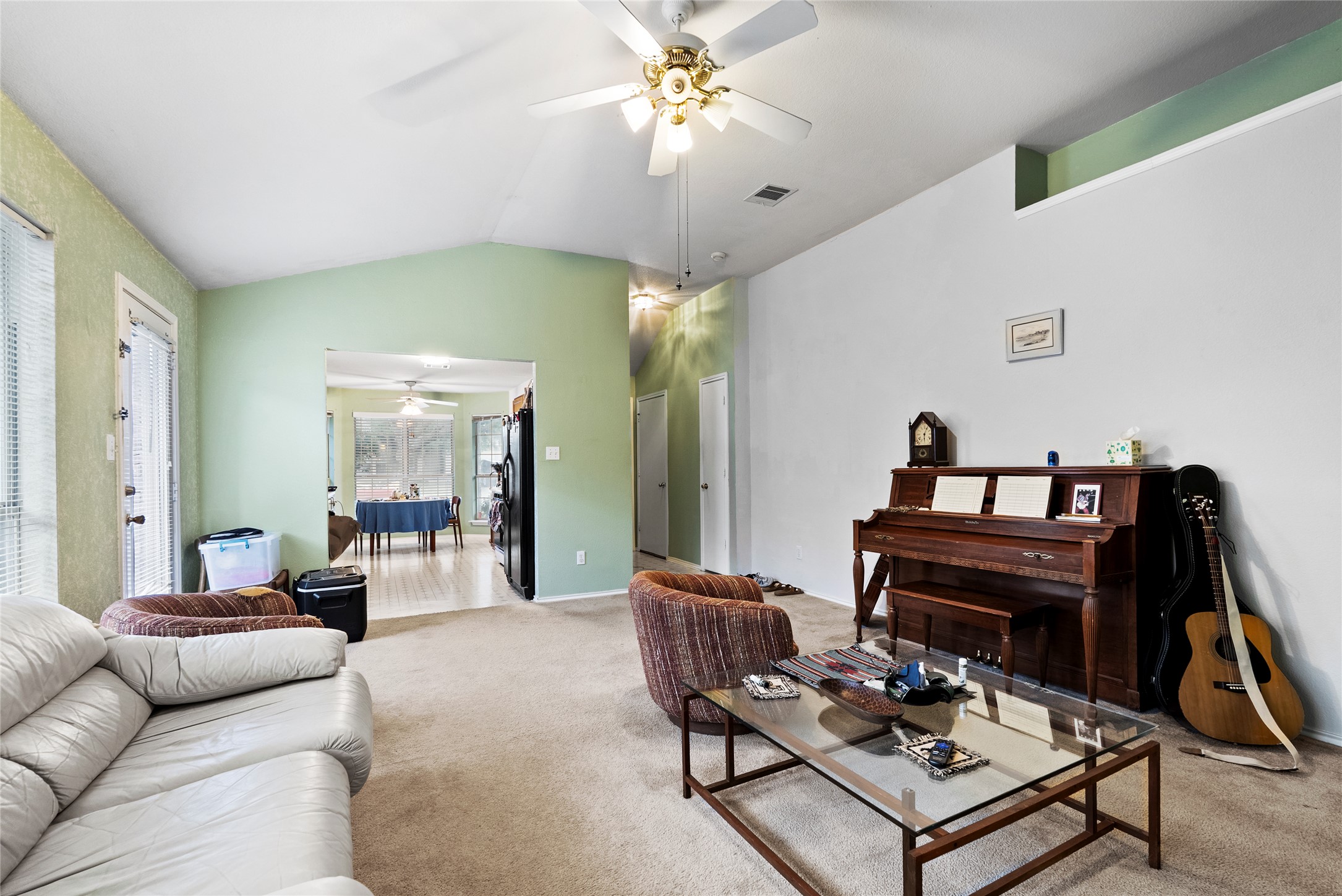 120 Shenandoah Trail Elgin, TX 78621 - Photo 6 of 16 Living area with lofted ceiling, carpet, and a ceiling fan.