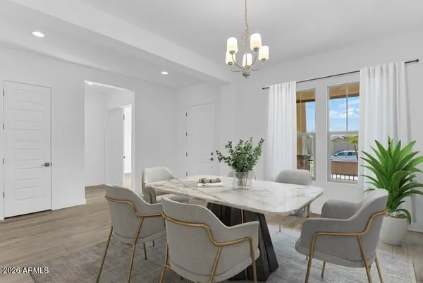 a view of a dining room with furniture and chandelier