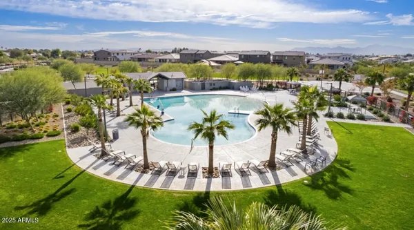 an aerial view of residential houses with outdoor space and swimming pool