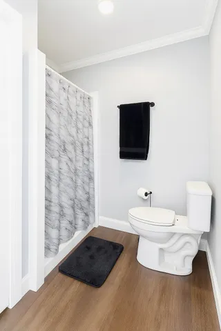 a bathroom with a toilet a sink and a mirror