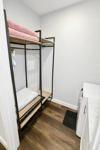 a view of a room with wooden floor