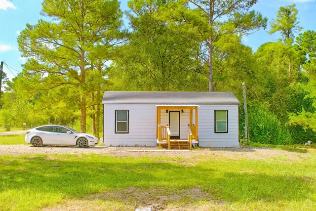 a front view of house with yard and trees