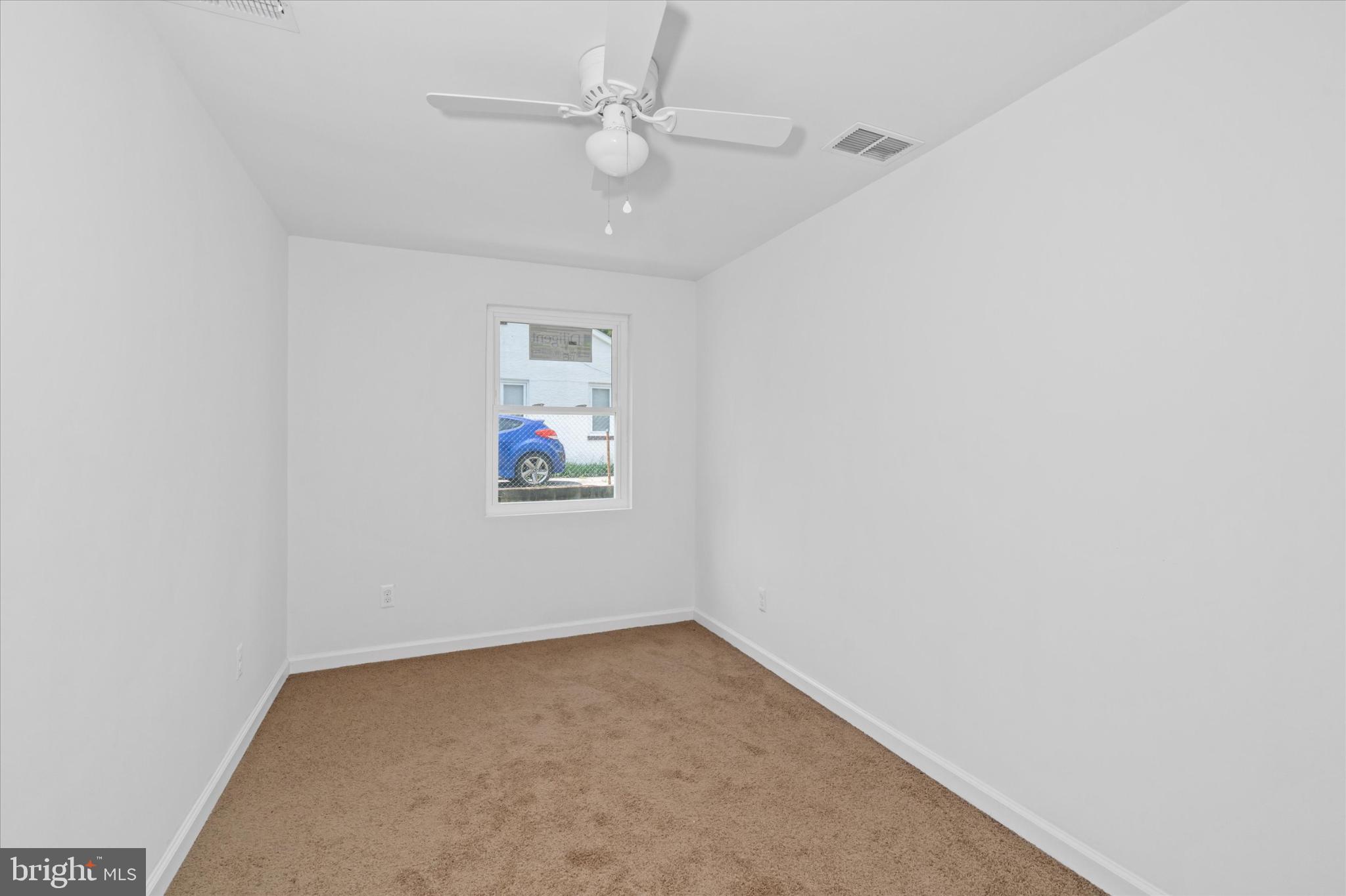 214 Keiser Place New Castle, DE 19720 - Photo 17 of 23 an empty room with a chandelier fan and windows