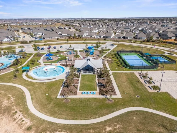 an aerial view of a swimming pool with outdoor seating