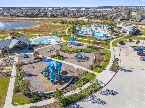 a view of a kitchen with wooden floor and a refrigerator