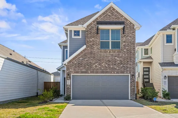 a large kitchen with stainless steel appliances a large counter top and a wooden floors