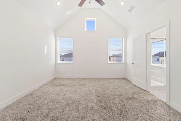 an empty room with closet and windows