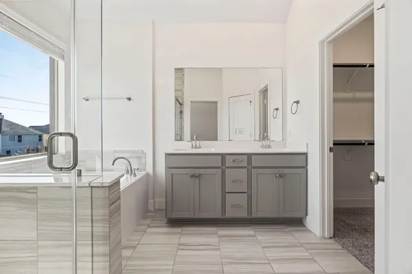 a bathroom with a shower sink and mirror
