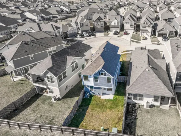 an aerial view of residential houses with yard