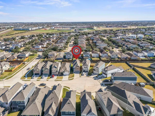 an aerial view of residential houses with outdoor space