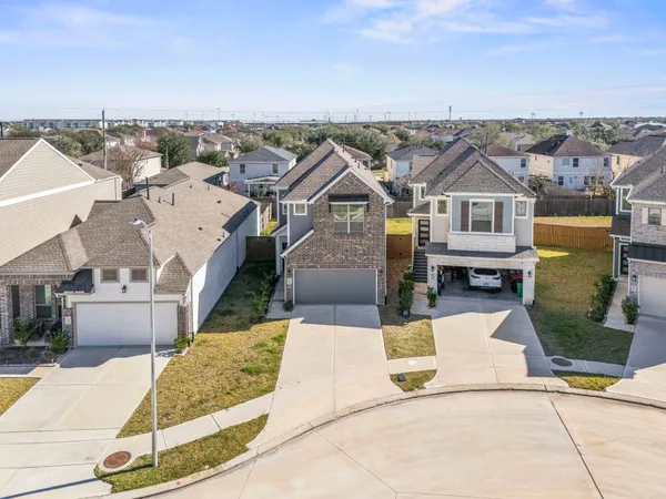 an aerial view of residential houses with outdoor space