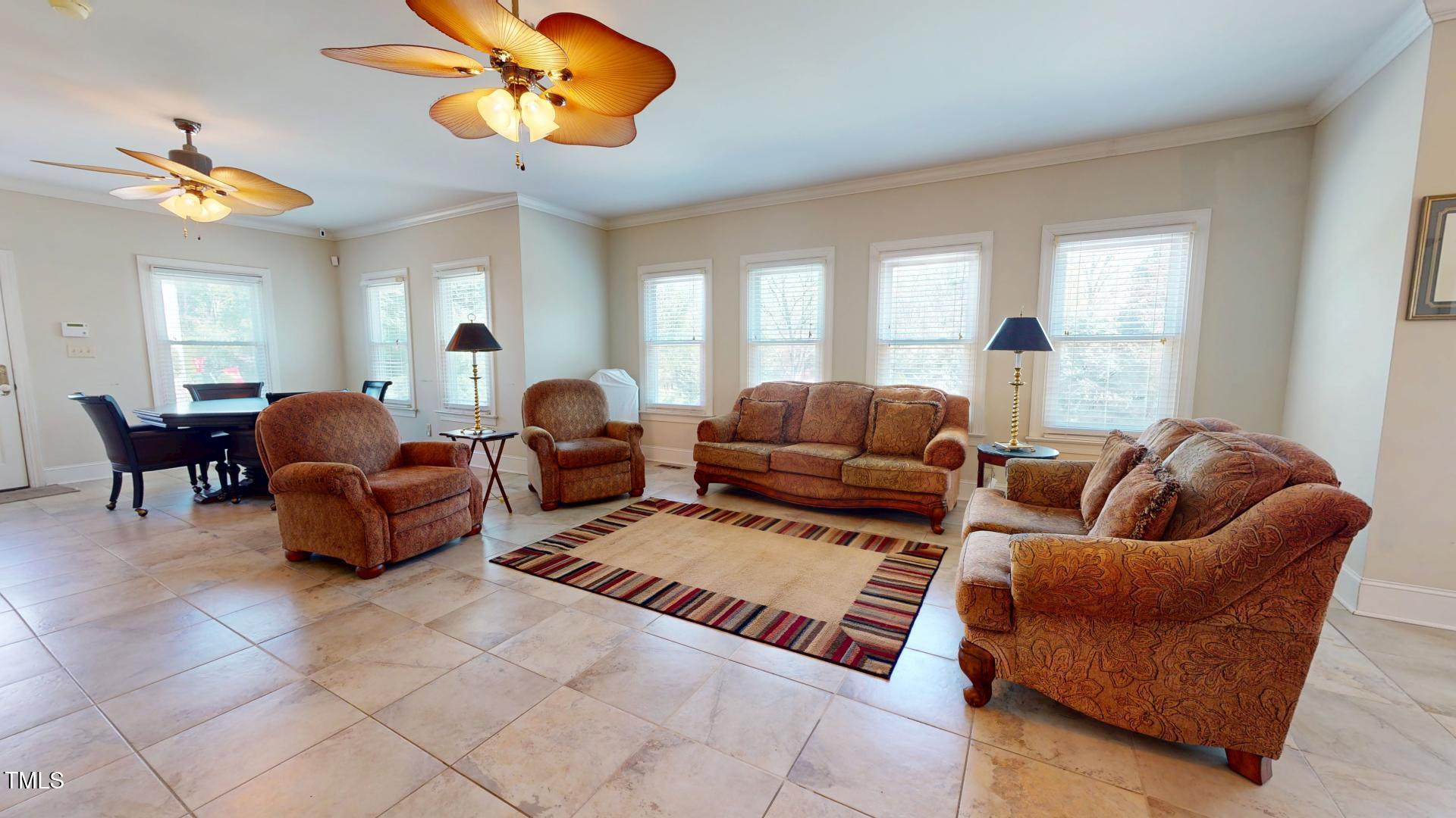 238 North Main Street Wake Forest, NC 27587 - Photo 11 of 100 a living room with furniture a chandelier and a large window