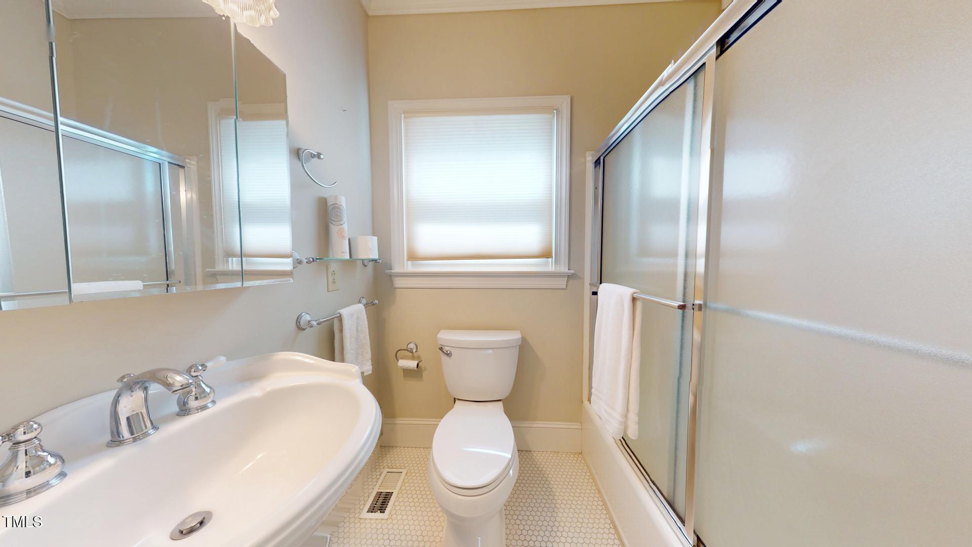 238 North Main Street Wake Forest, NC 27587 - Photo 18 of 100 a bathroom with a toilet sink and mirror