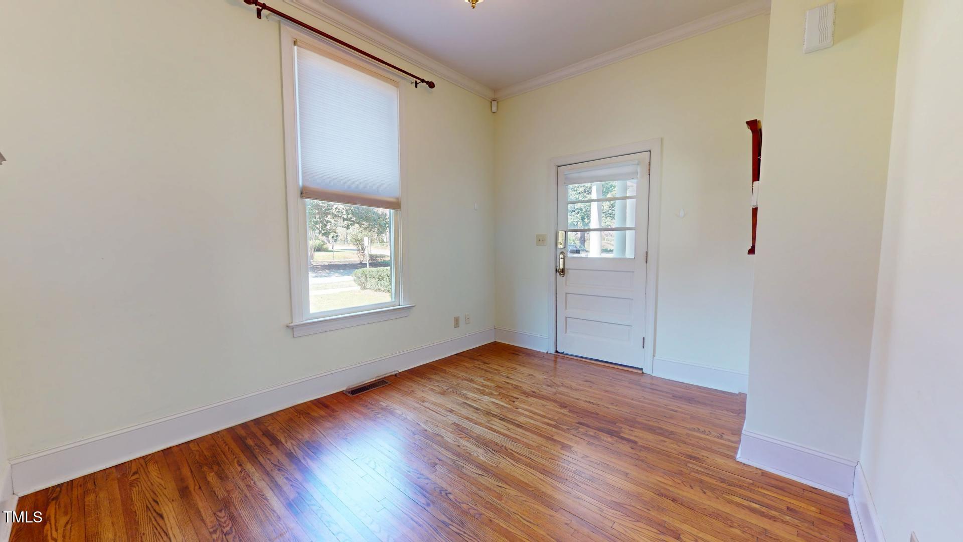 238 North Main Street Wake Forest, NC 27587 - Photo 22 of 100 an empty room with wooden floor and windows
