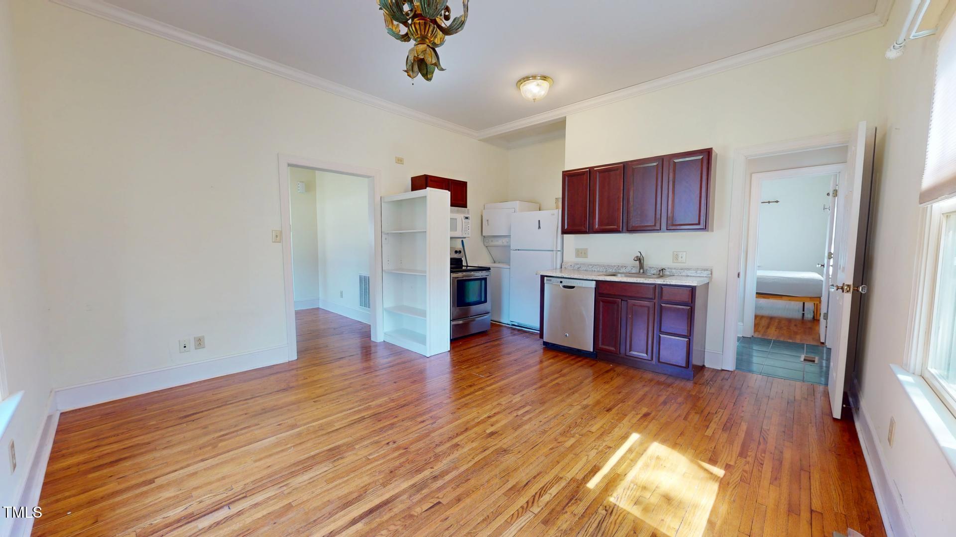 238 North Main Street Wake Forest, NC 27587 - Photo 23 of 100 a room with wooden floor and furniture