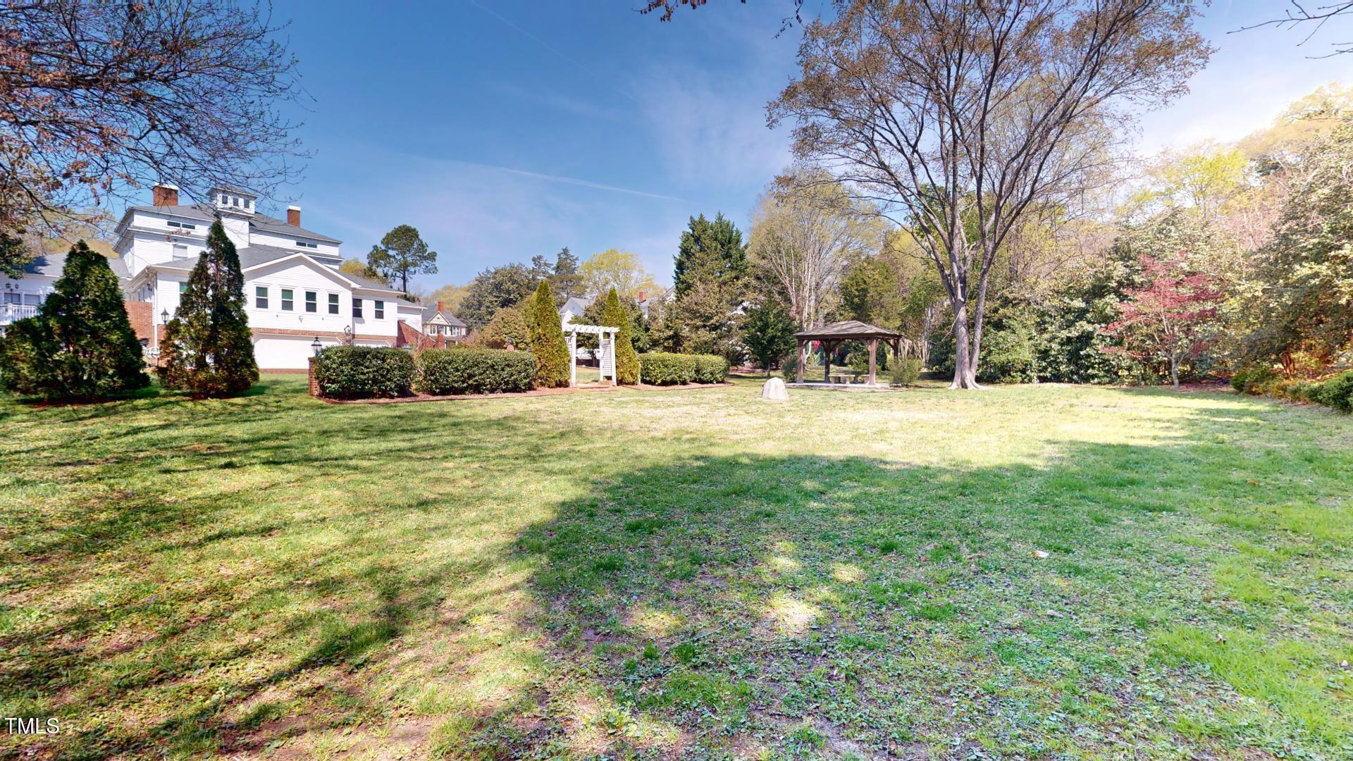238 North Main Street Wake Forest, NC 27587 - Photo 52 of 100 a view of a building with a big yard and large trees