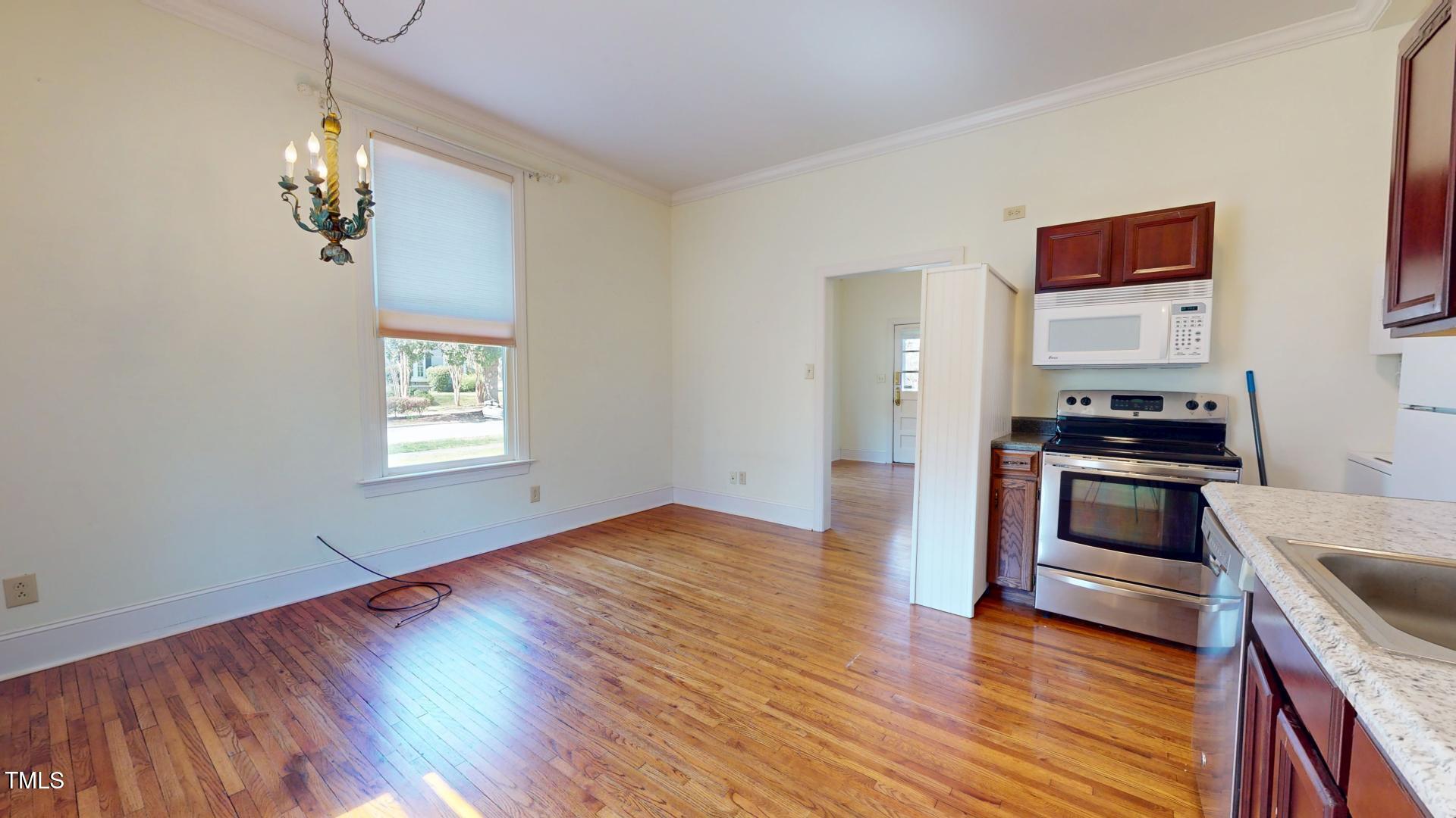238 North Main Street Wake Forest, NC 27587 - Photo 68 of 100 a kitchen with wooden floors and stainless steel appliances