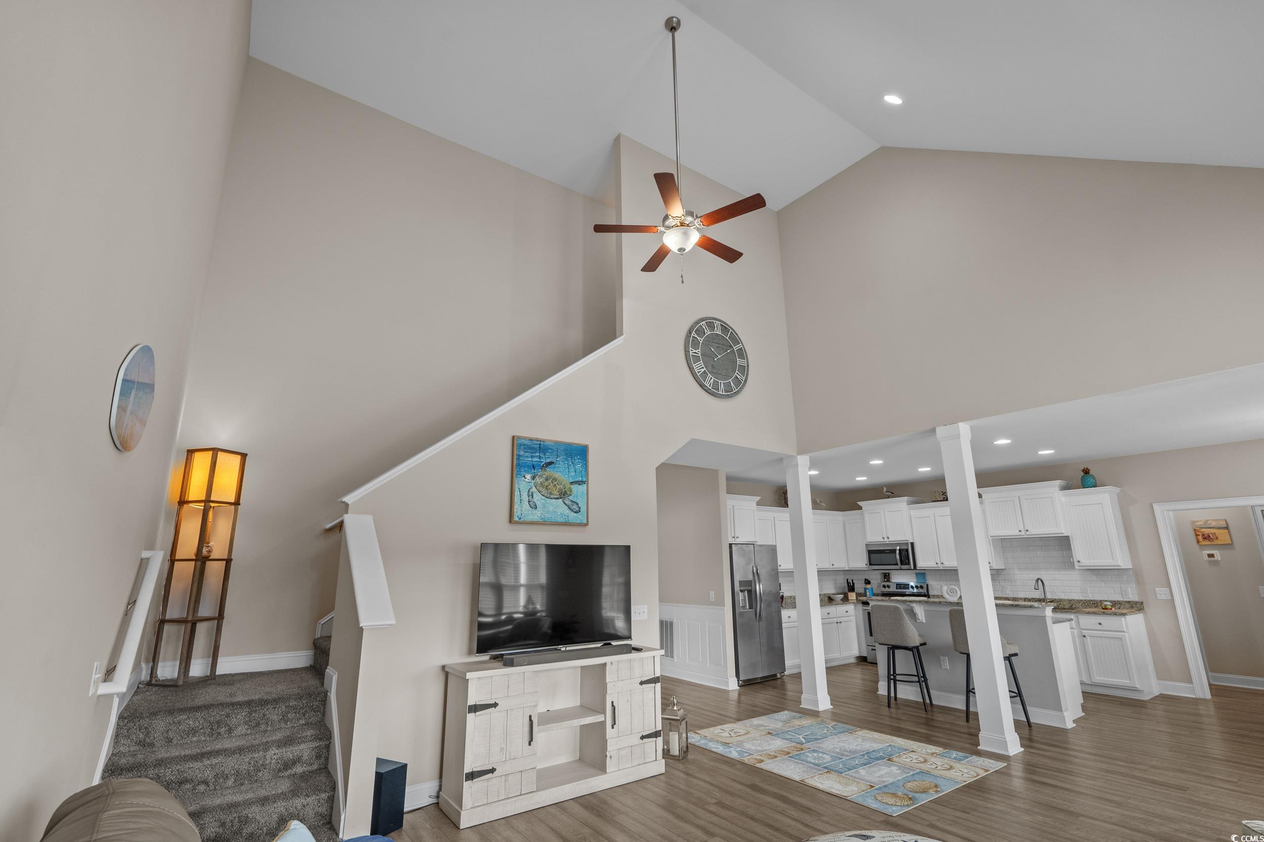 3624 Edwards Road Aynor, SC 29511 - Photo 11 of 40 Living area featuring dark wood finished floors, high vaulted ceiling, recessed lighting, stairs, and ceiling fan