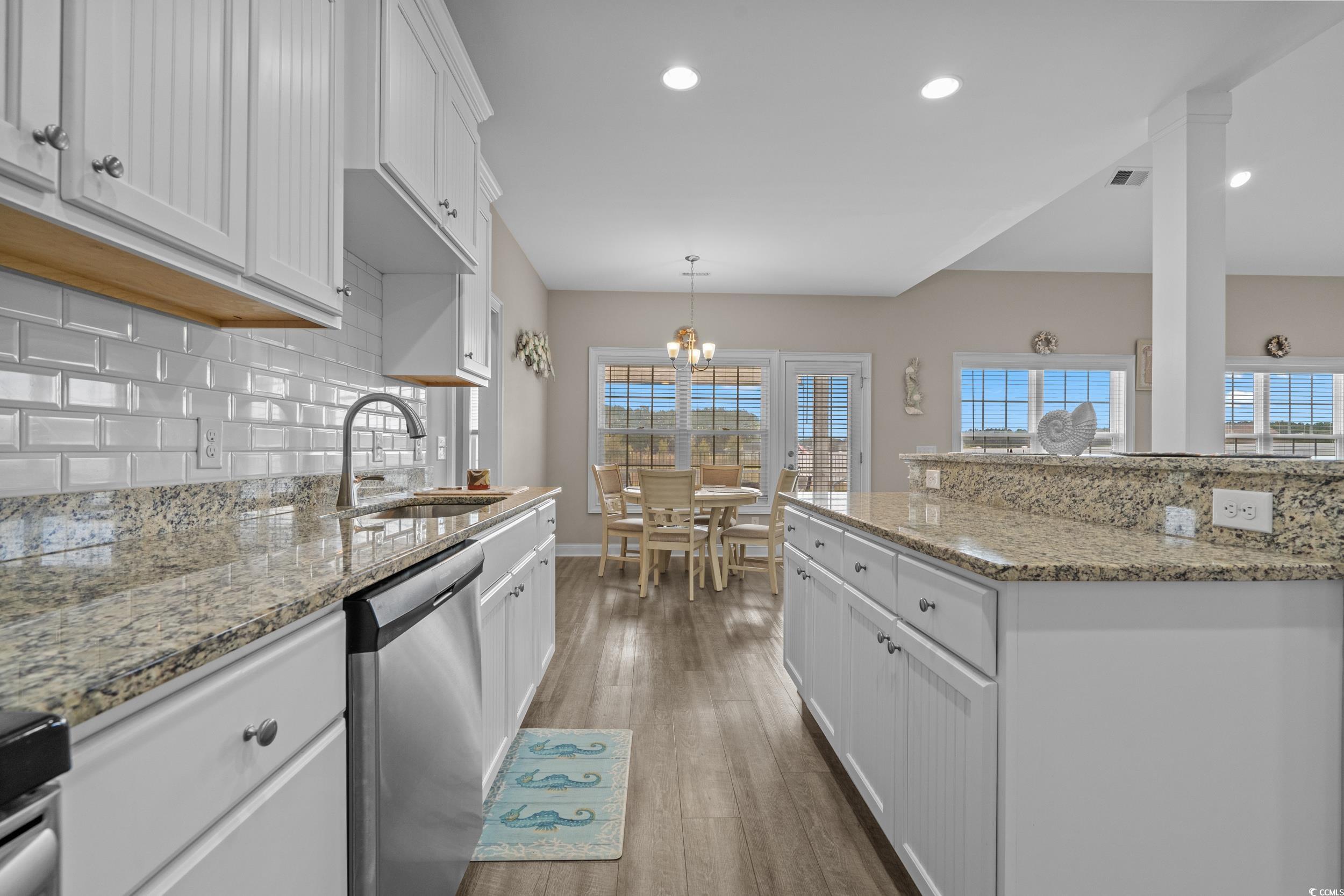 3624 Edwards Road Aynor, SC 29511 - Photo 12 of 40 Kitchen featuring white cabinets, stainless steel dishwasher, recessed lighting, light stone countertops, and backsplash