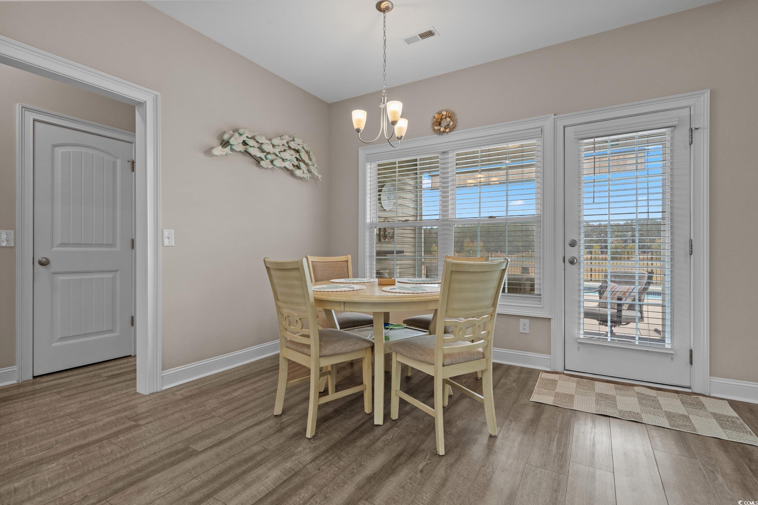 3624 Edwards Road Aynor, SC 29511 - Photo 14 of 40 Dining room with light wood-type flooring and a chandelier