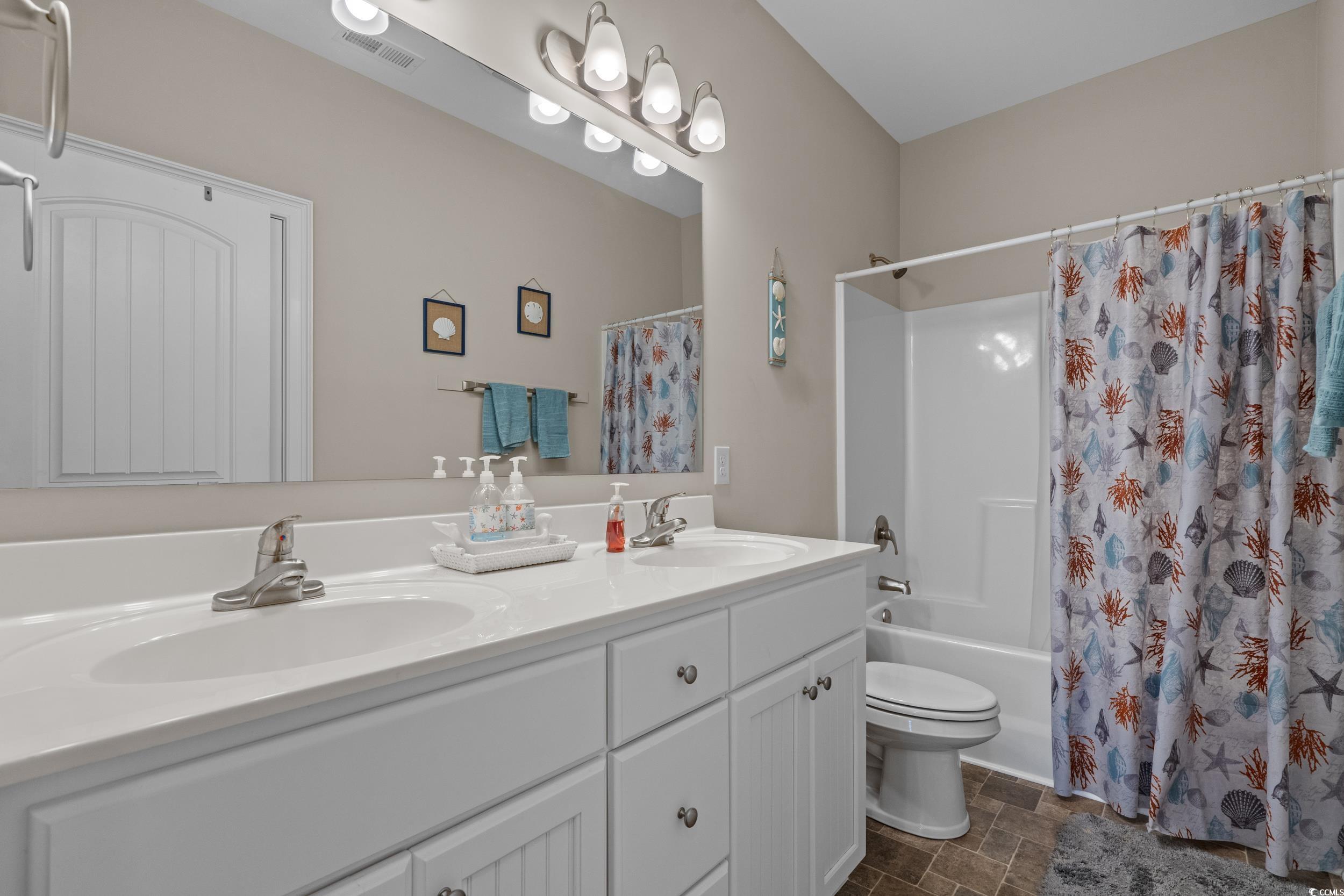 3624 Edwards Road Aynor, SC 29511 - Photo 30 of 40 Bathroom with double vanity, shower / tub combo, and dark stone finish floors