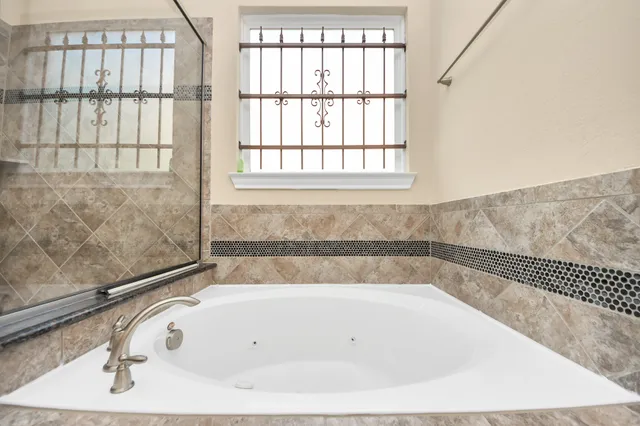 a bathroom with a bathtub and a window