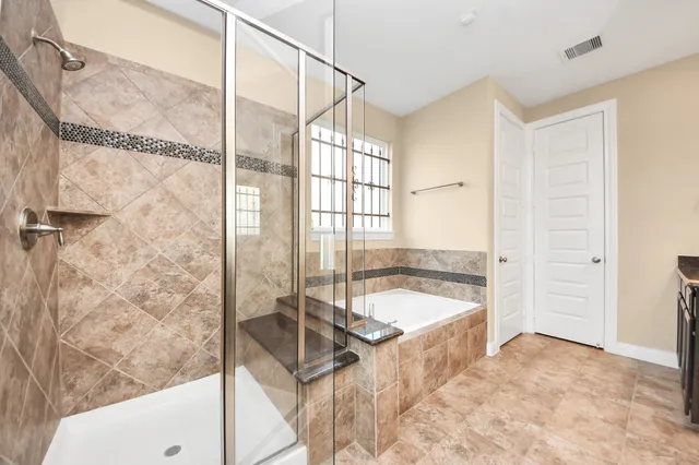 a spacious bathroom with a tub and a shower