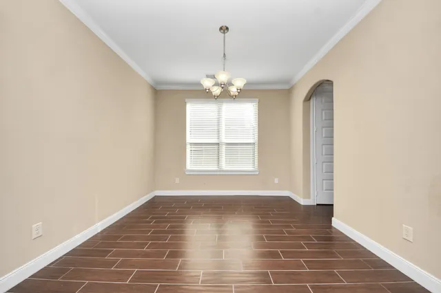 a view of a room with window and chandelier
